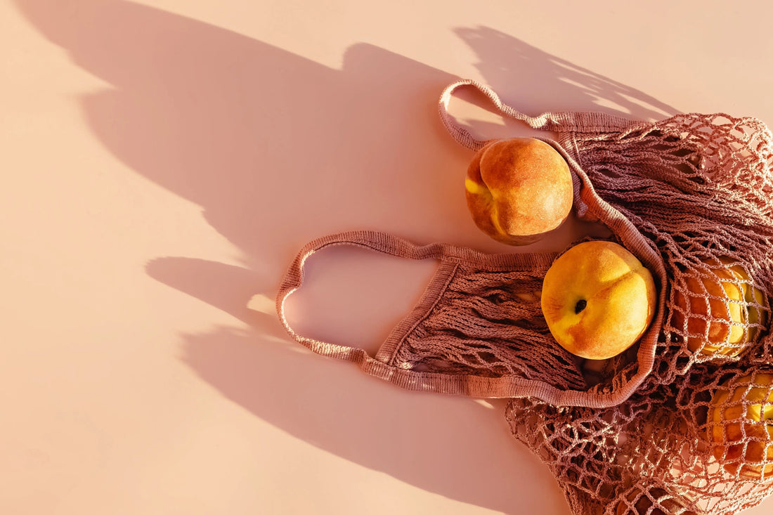 Bag of oranges and citrus fruits to provide vitamin C and help increase collagen production naturally in the skin