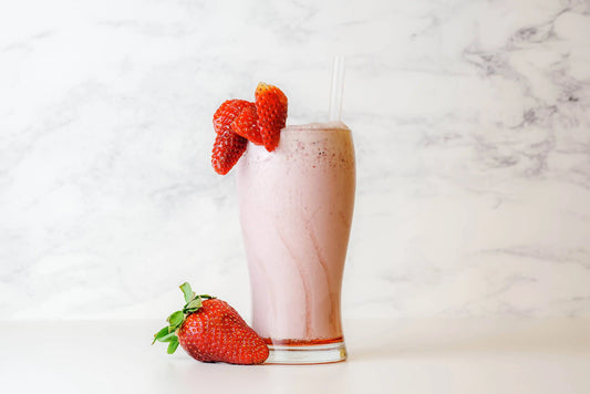 Healthy strawberry smoothie with collagen boosting antioxidants in a glass on a table