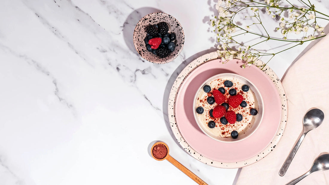 vegan collagen breakfast of oats and berries in a bowl with vegan collagen powder