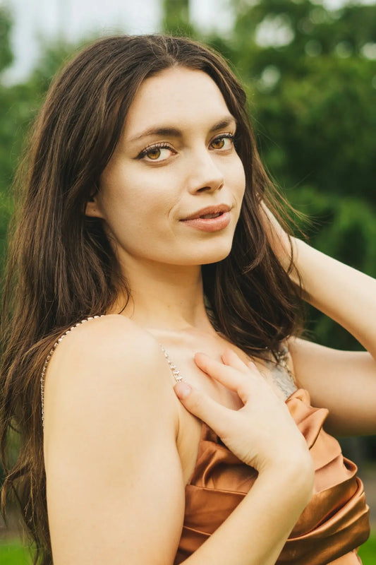 a woman in a brown dress posing for a picture