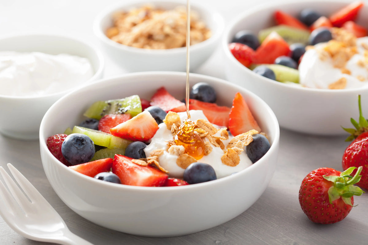 Bowl of granola and fruit and yoghurt that can help build collagen