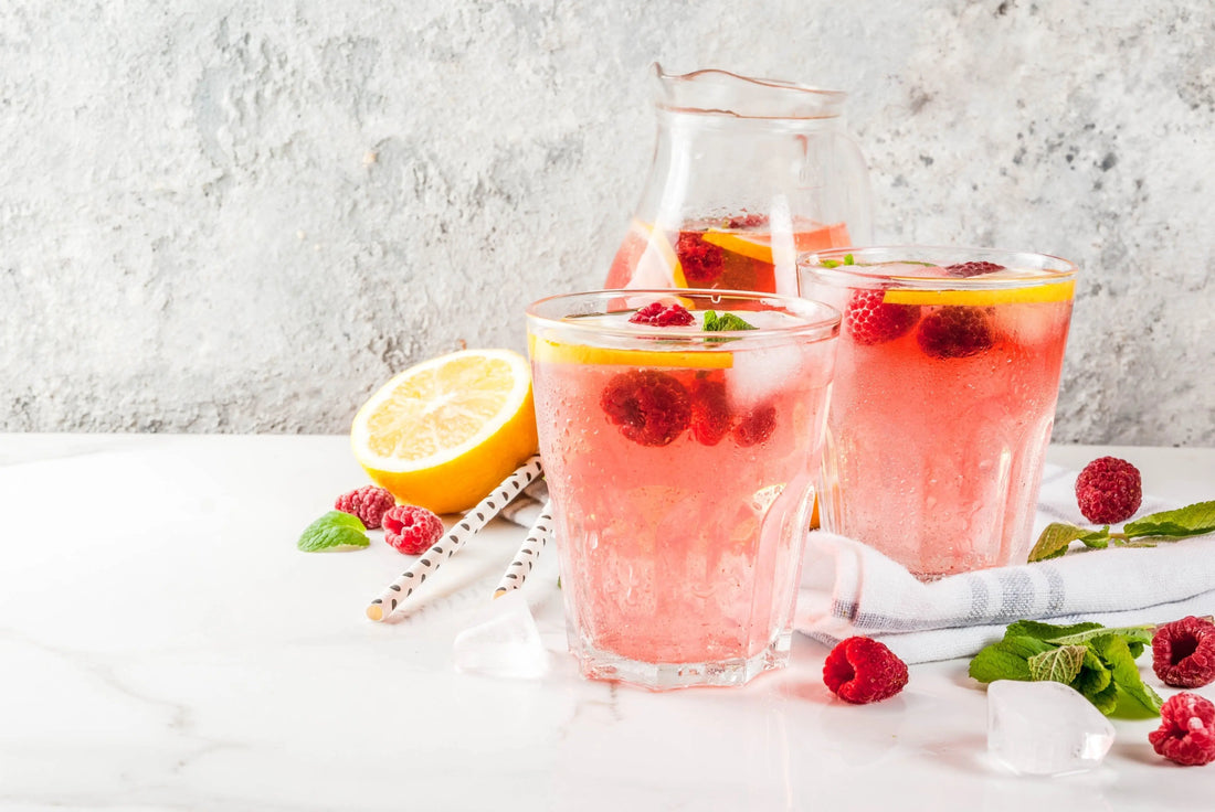 Glasses of water naturally flavoured with raspberries to make it taste better