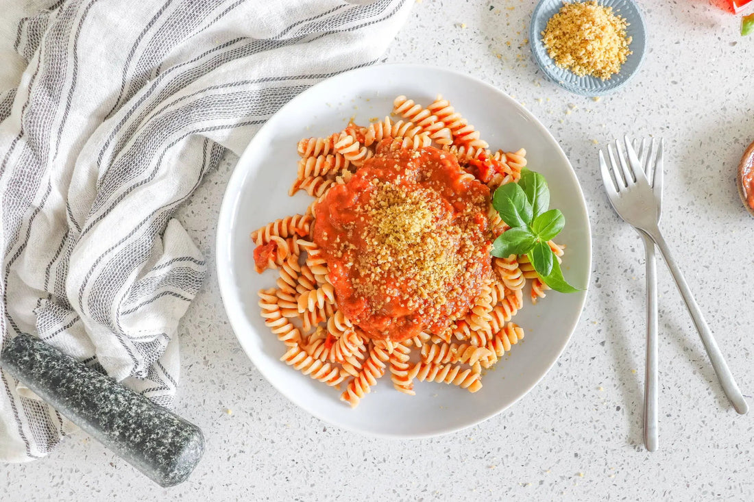 Healthy vegan pasta with tomato sauce and vegan walnut parmesan for a quick lunch or dinner 