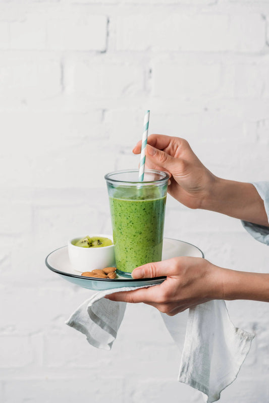 Healthy green smoothie in a glass to help get rid of wrinkles & keep skin clear & glowing with spinach, avocado & chia seeds