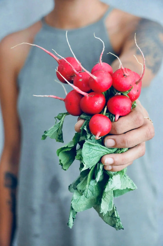 woman holding horseradish