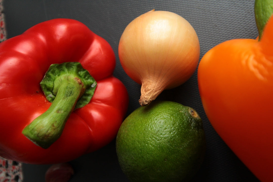 red and yellow bell pepper beside green chili