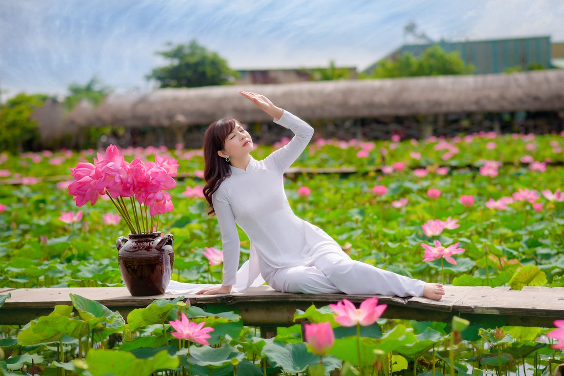 woman in white dress sitting on brown wooden bench