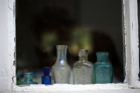 clear glass bottles on white table