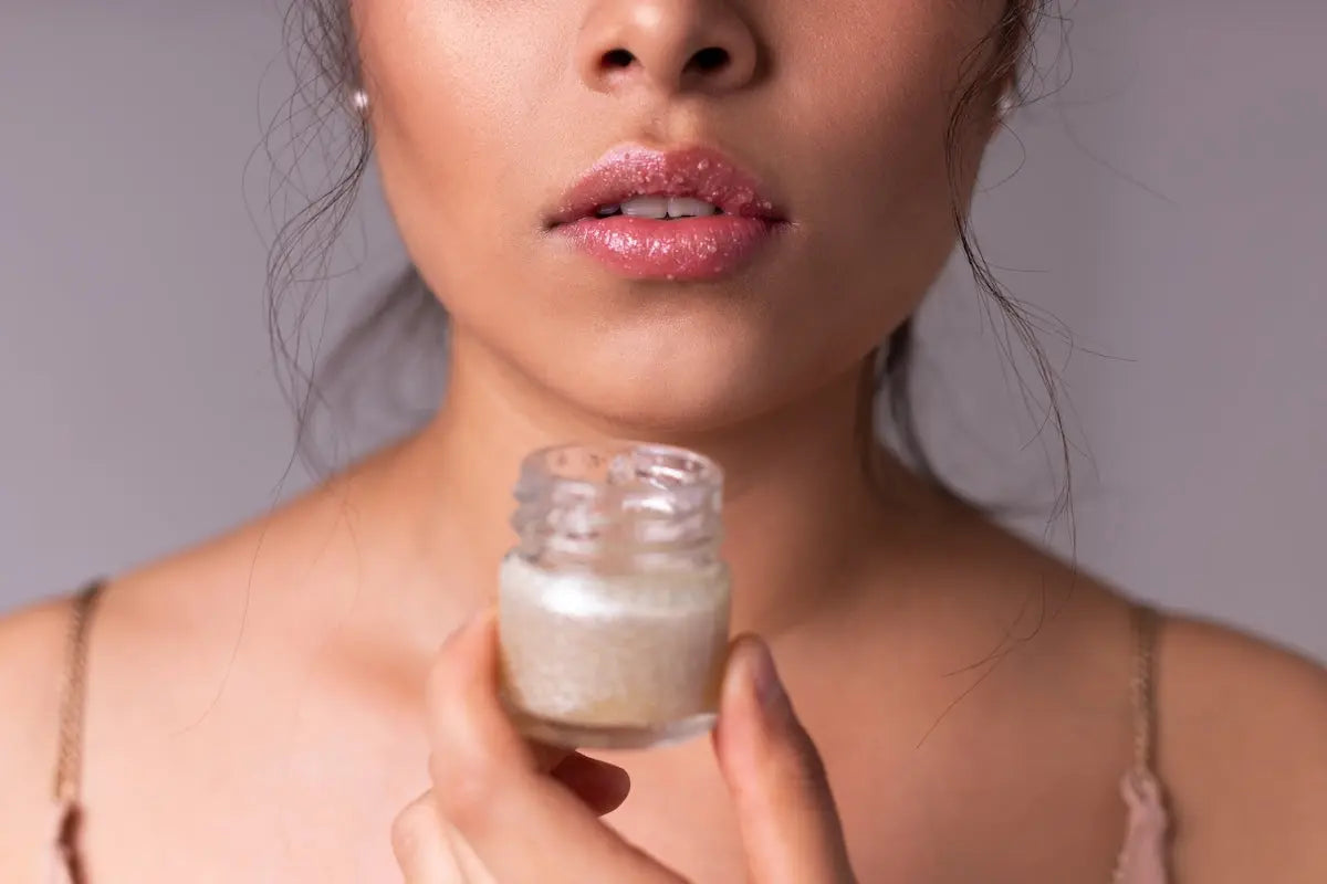woman holding white plastic bottle