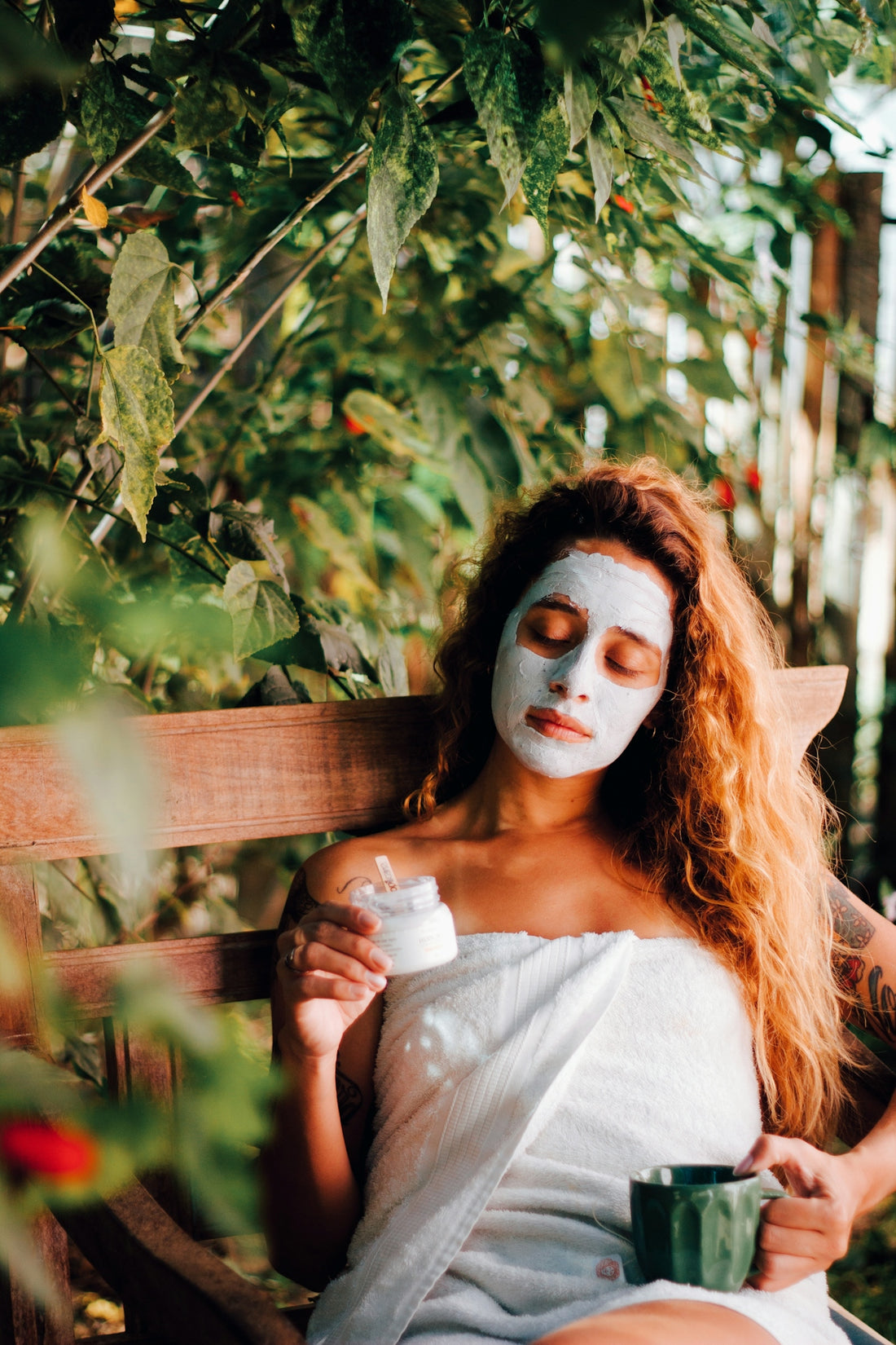 a woman with a face paint holding a cup