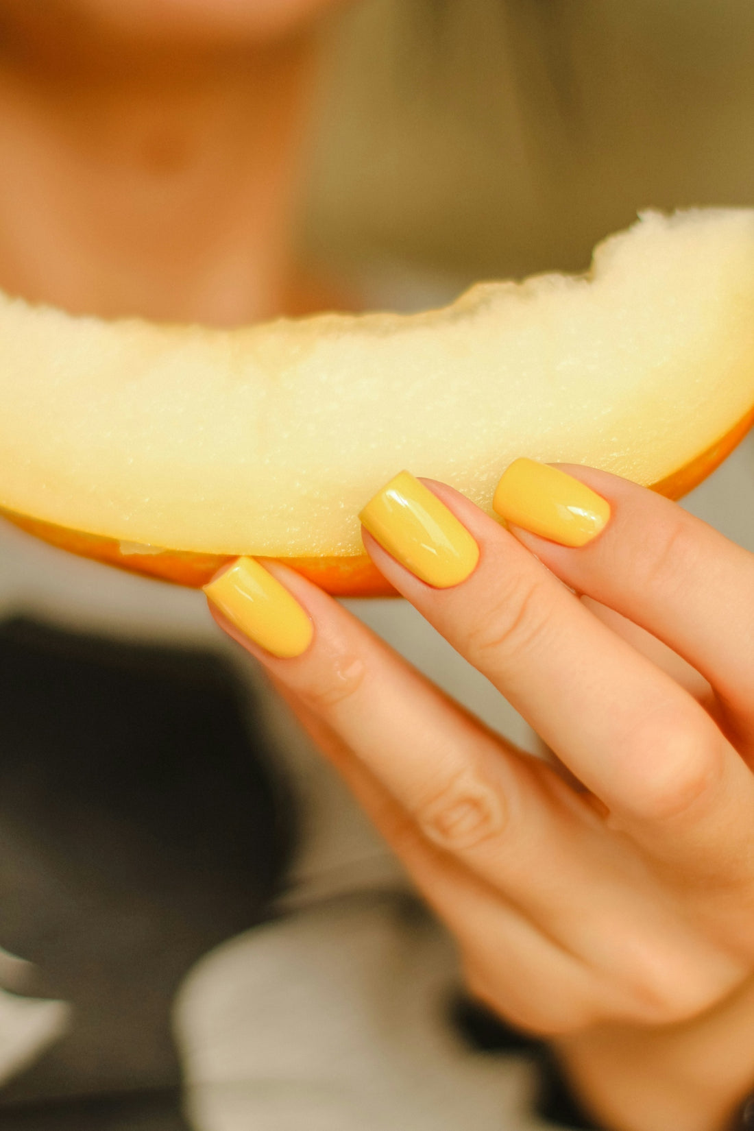 a person holding a slice of cheese
