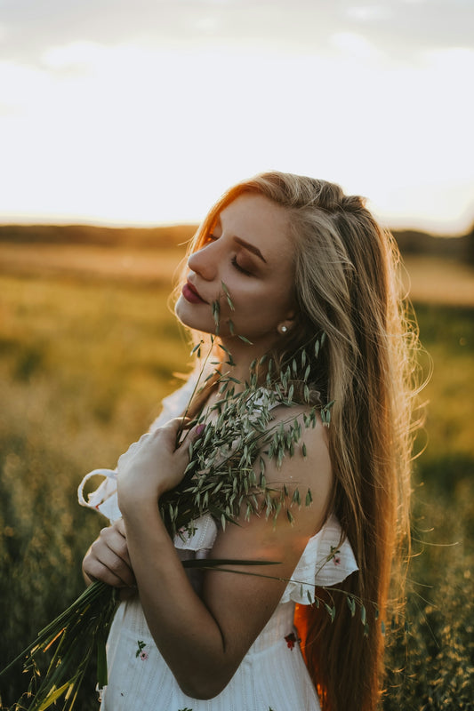 a woman with long hair in a field