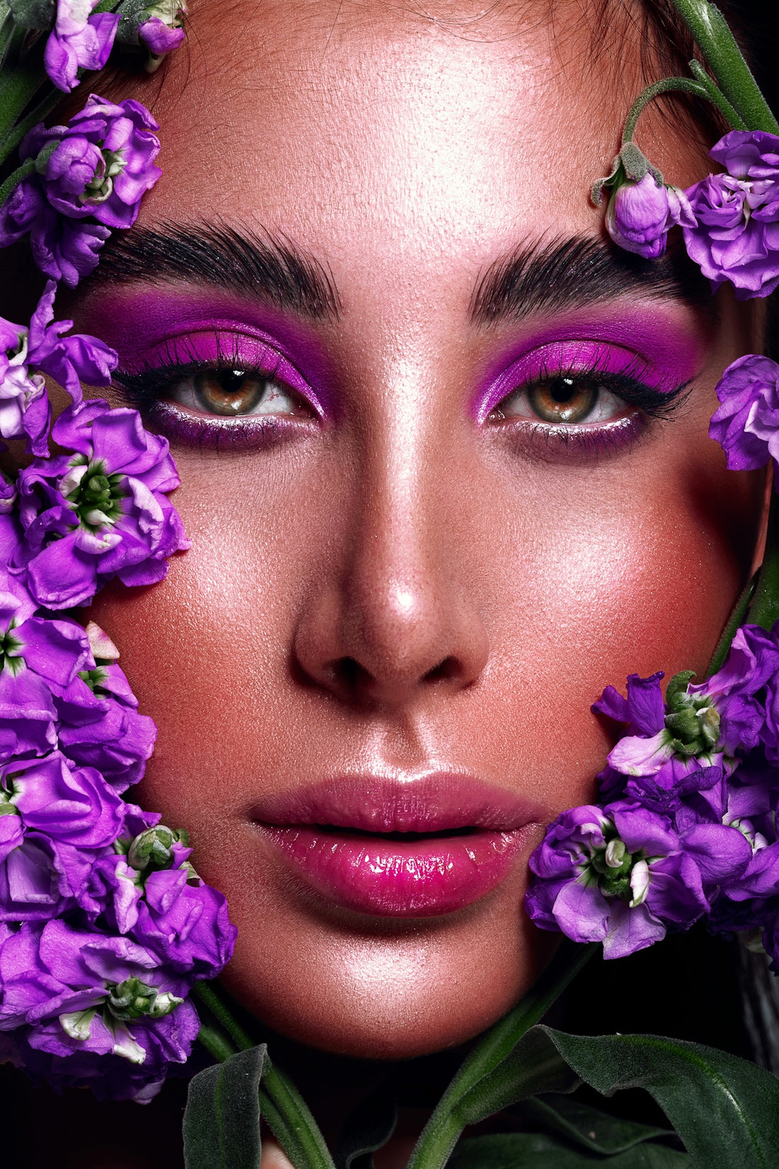 a woman with purple flowers around her face