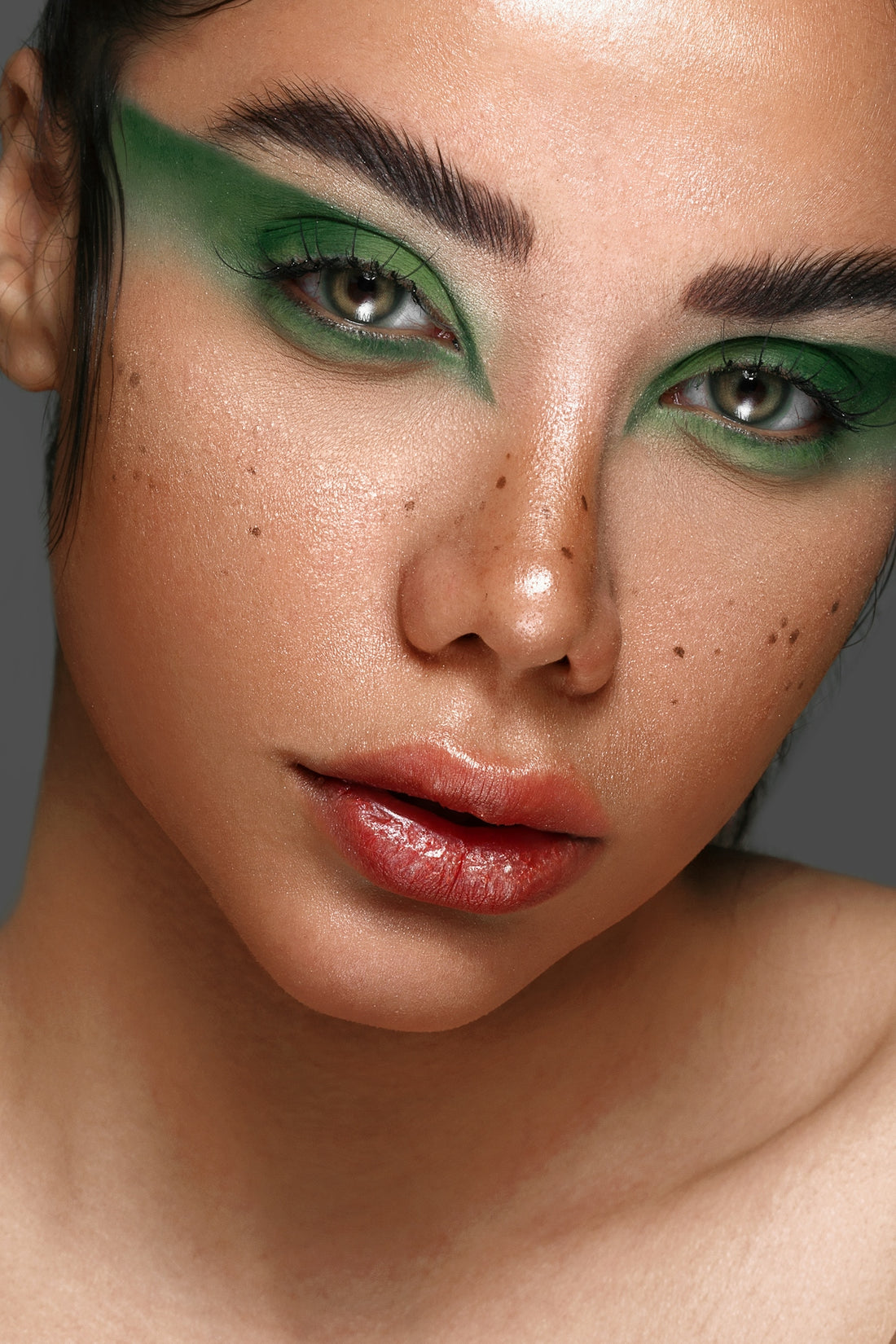 a close up of a woman with green makeup