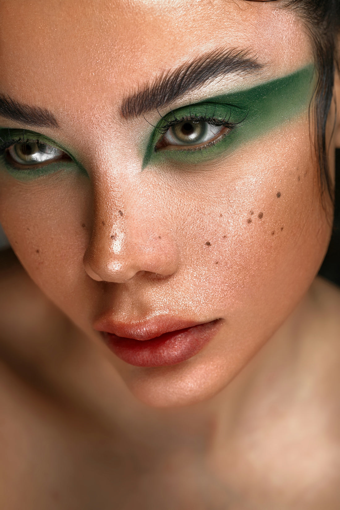 a close up of a woman with green makeup