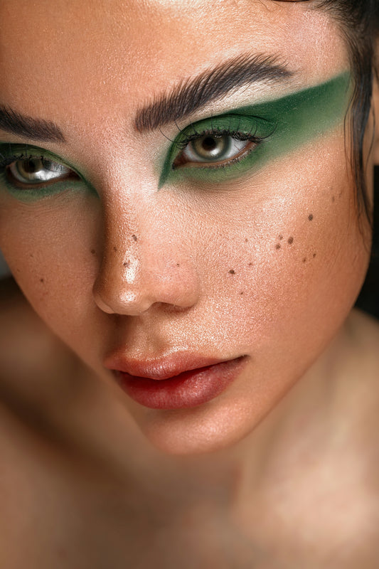 a close up of a woman with green makeup