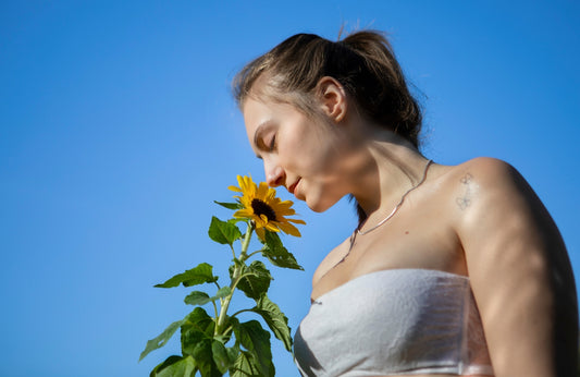 a woman with a sunflower in her hand