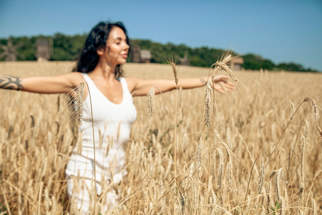 A woman standing in a field of wheat