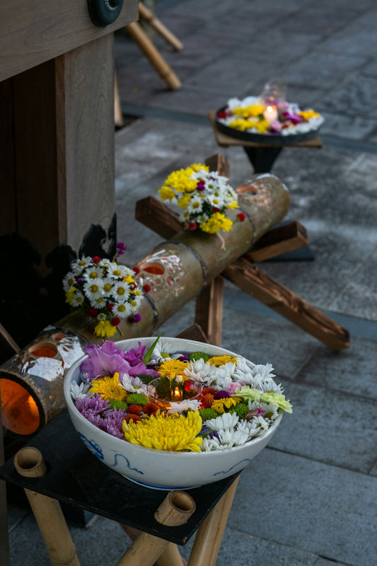 A bowl of flowers sitting on top of a table