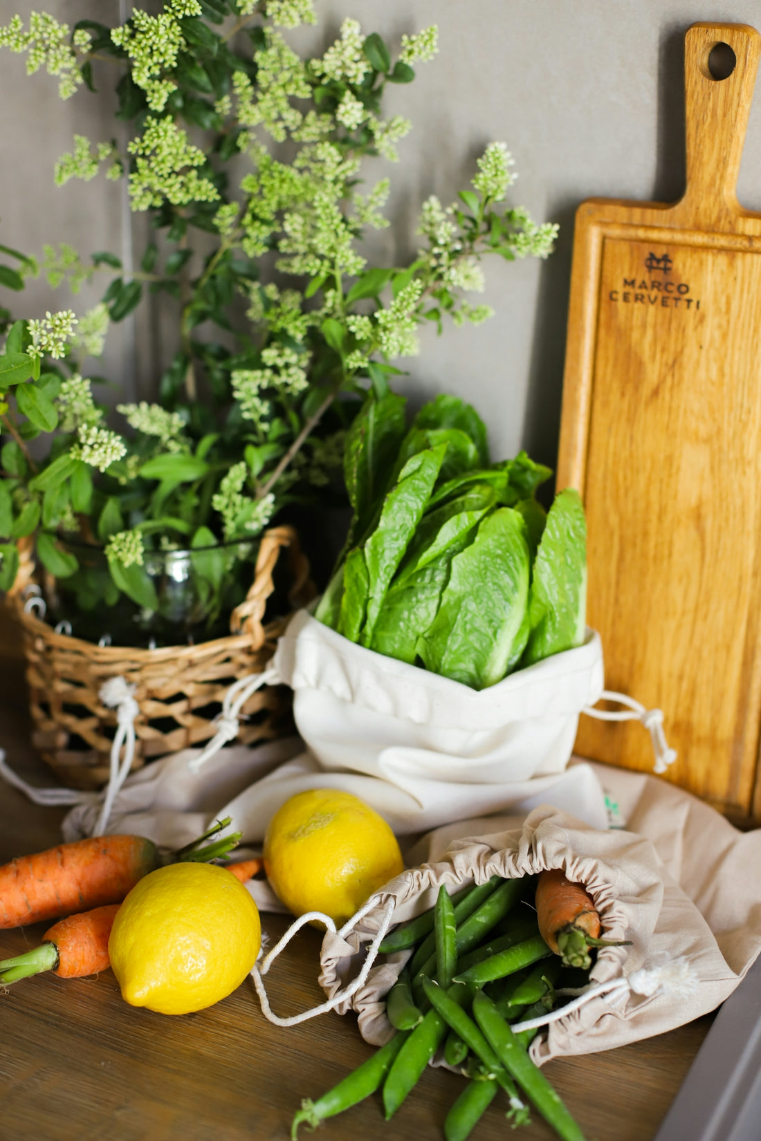 A bunch of vegetables sitting on a table next to a cutting board