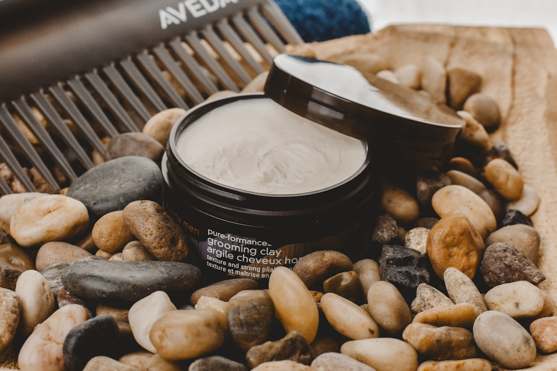 A jar of cream sitting on top of a pile of rocks