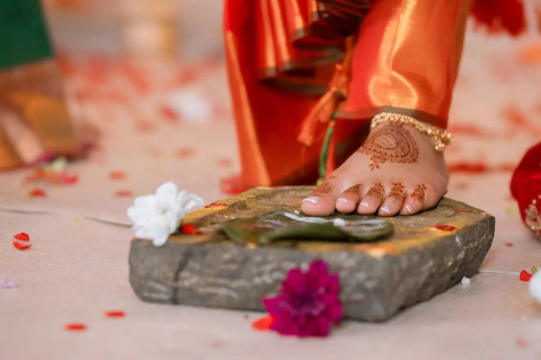 A bride's foot during a traditional indian wedding.