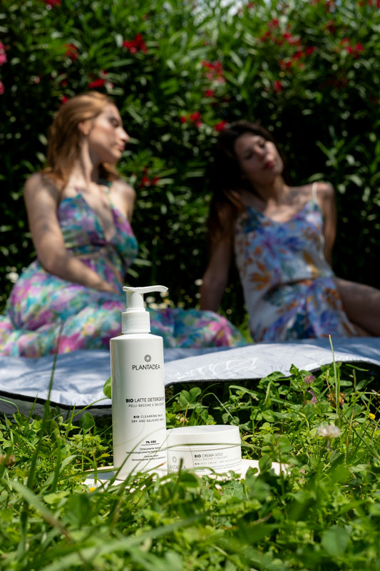 Skincare products are displayed with two women outside.