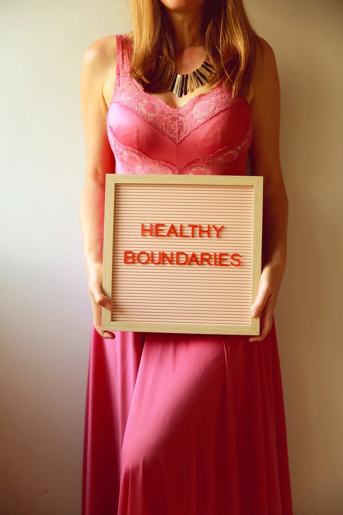 Woman holds a sign promoting healthy boundaries.