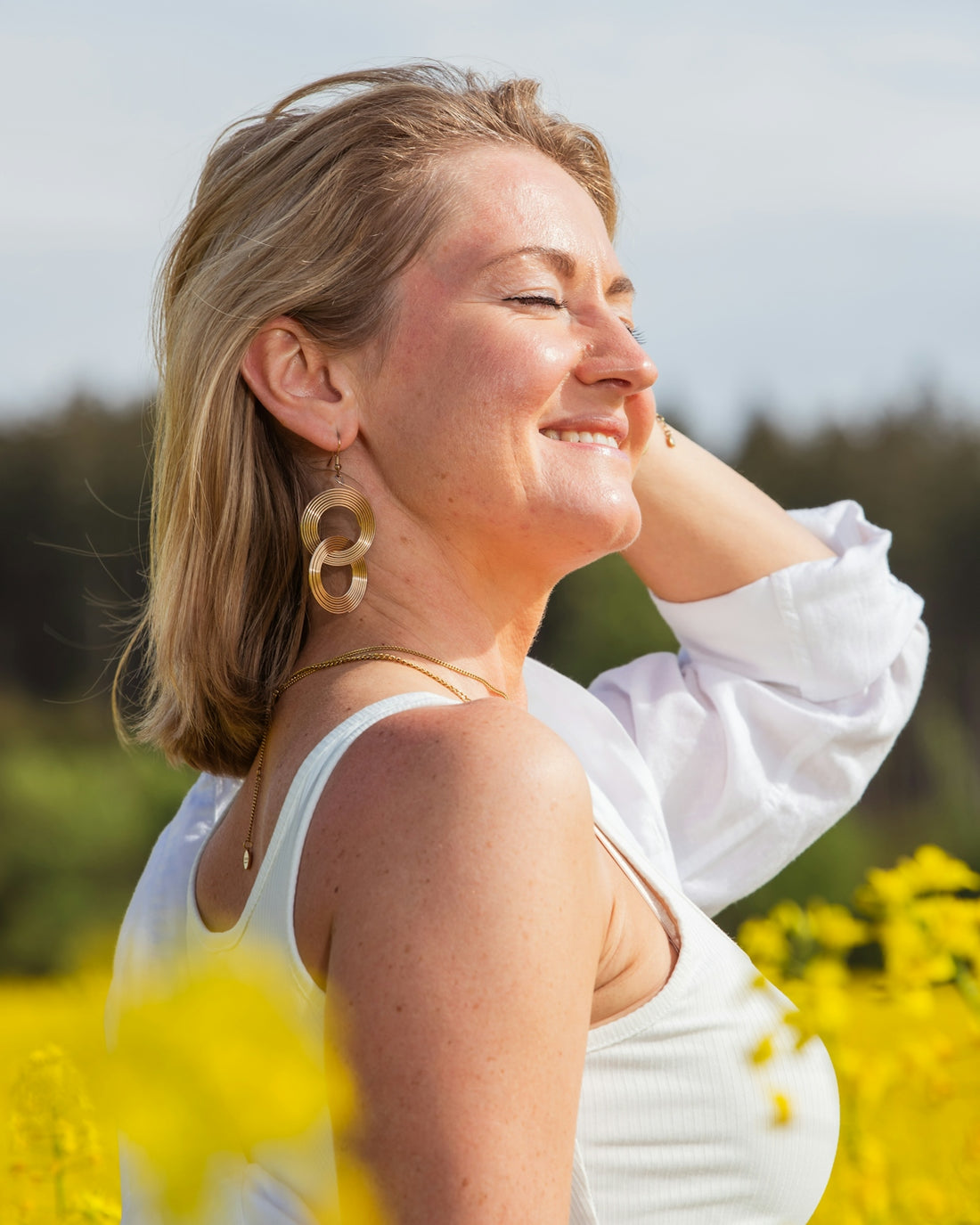 Happy woman enjoys a sunny day in a field.