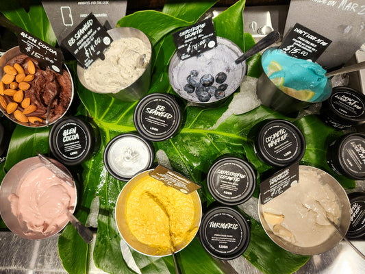 Fresh face masks are displayed on greenery.