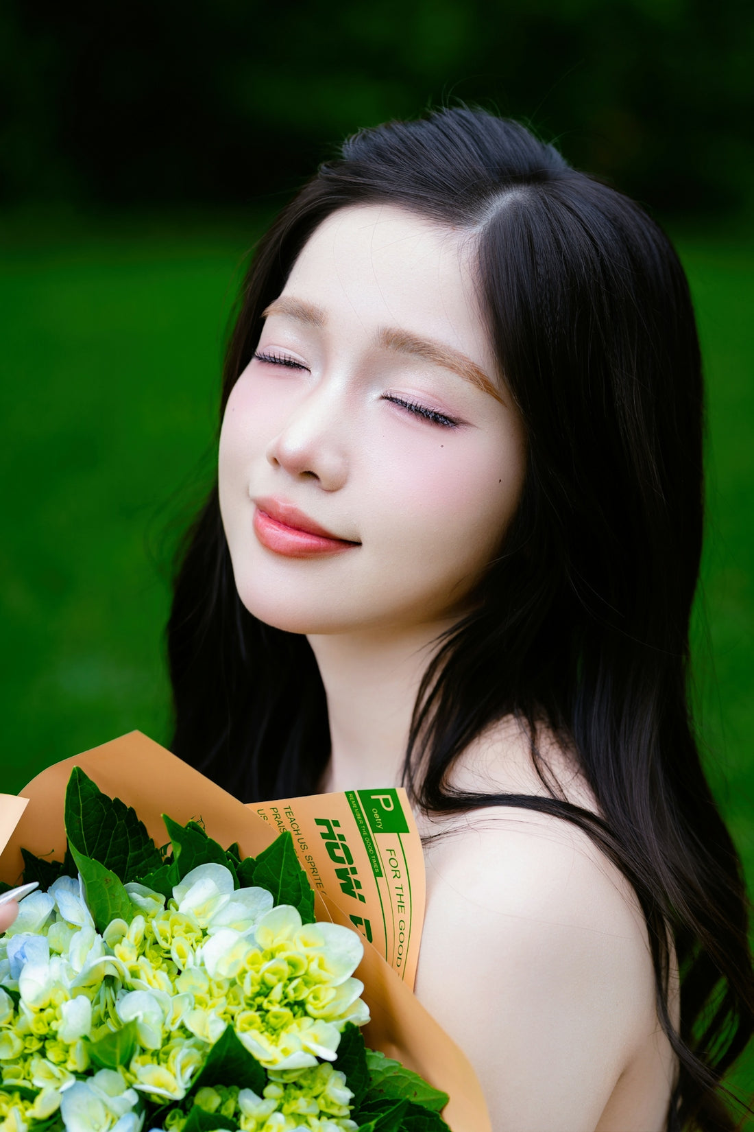 Young woman with eyes closed holding a bouquet of flowers