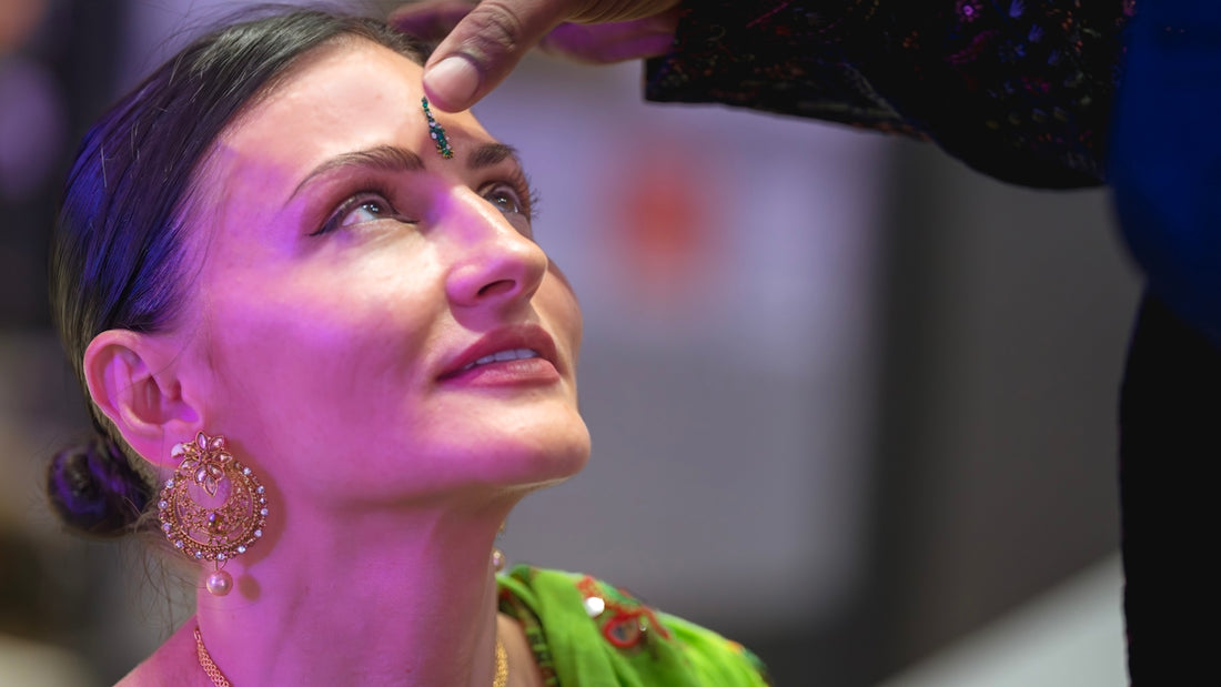 Woman receives a blessing on her forehead