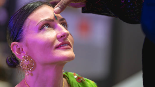 Woman receives a blessing on her forehead