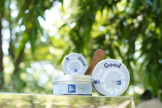 Two jars of the good body butter with spatula.