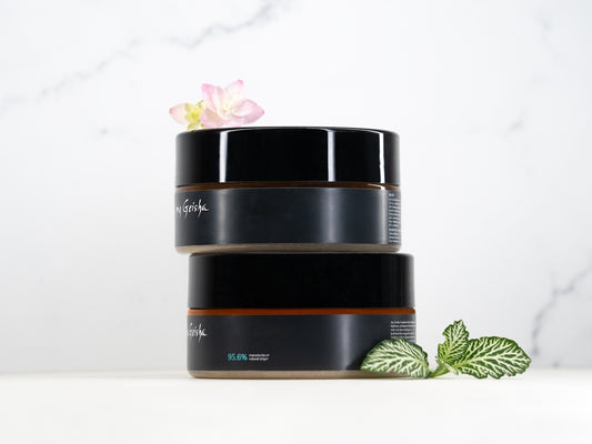 Two cosmetic jars stacked with plants and plants