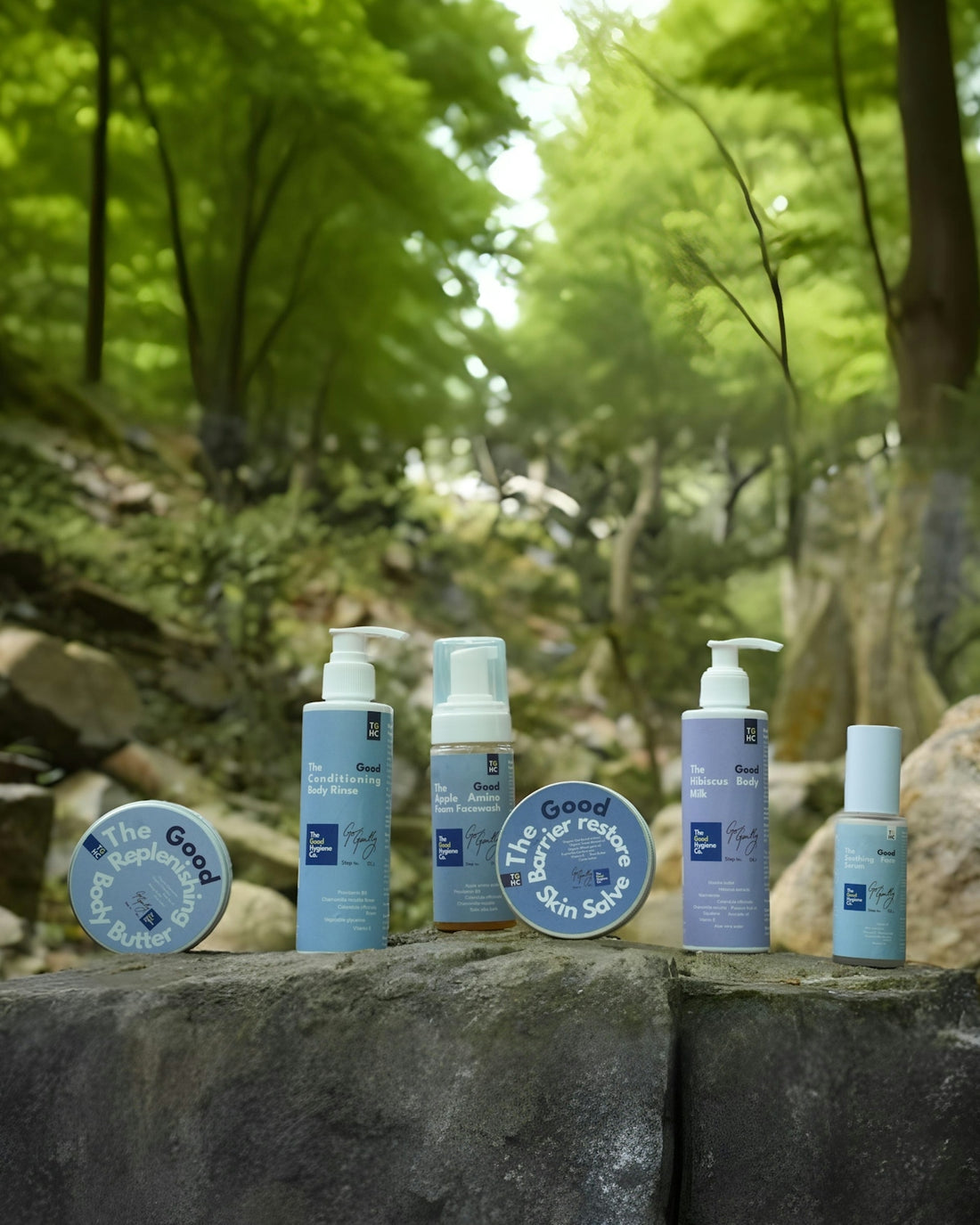 Skincare products displayed on rocks with forest background.