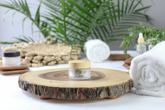 Skincare product on a wooden slice with towels