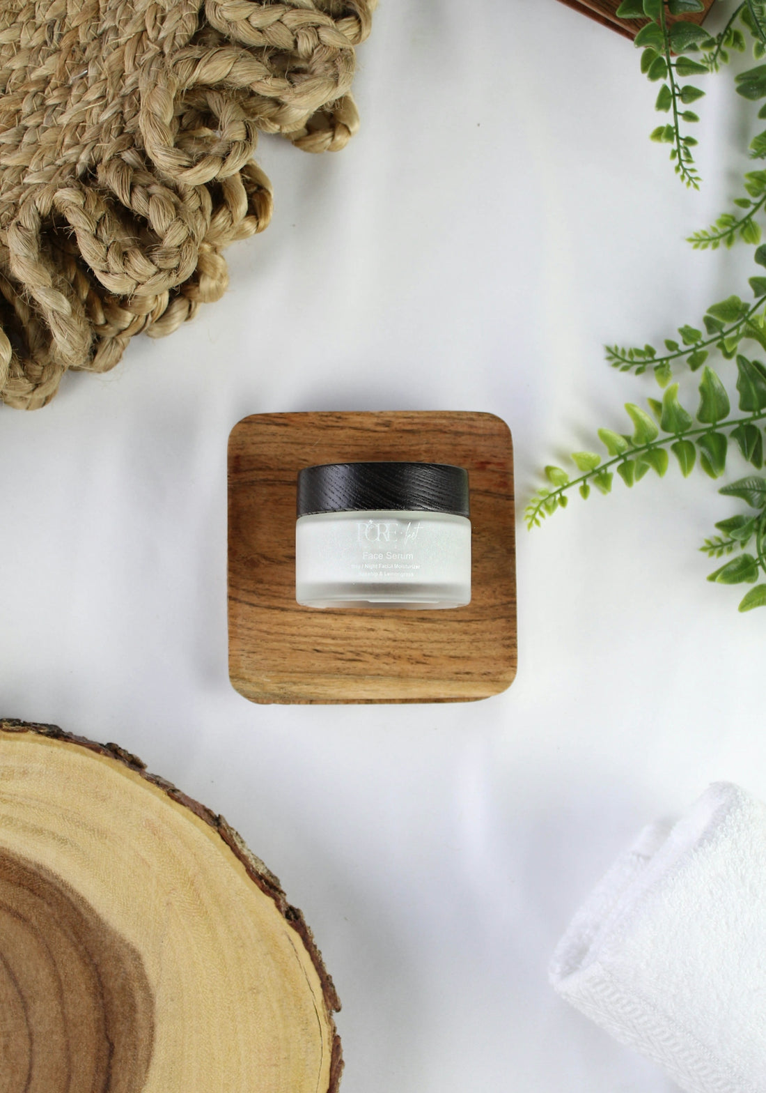 A small jar of cream on a wooden stand.