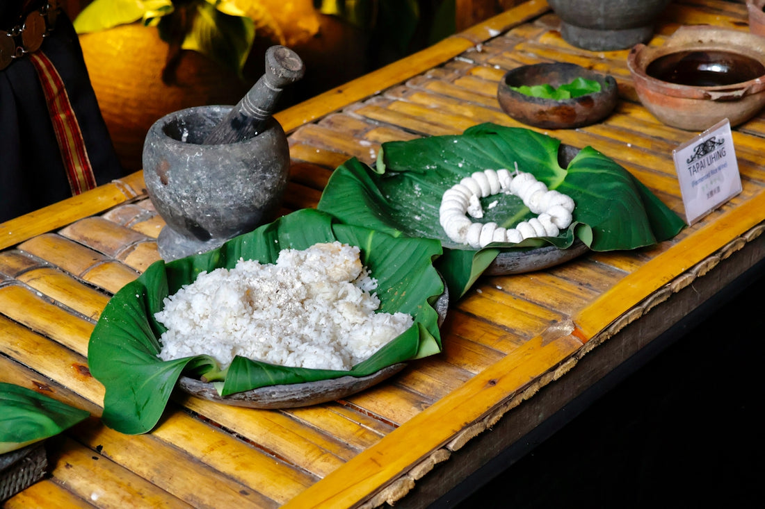 Rice dish served on banana leaves with mortar and pestle