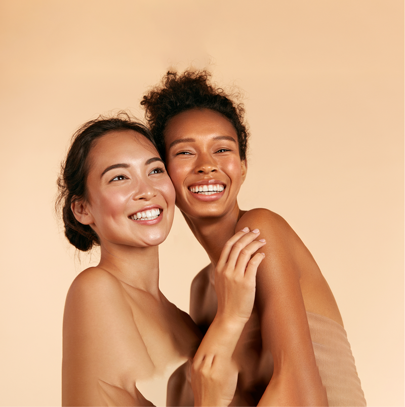 2 women with glowing skin laughing for raw beauty lab discount