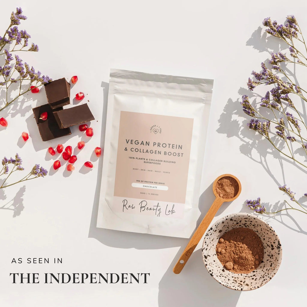 Flatlay of Vegan Protein and Collagen Builder with coffee and flowers – clean plant-based protein for skin and strength