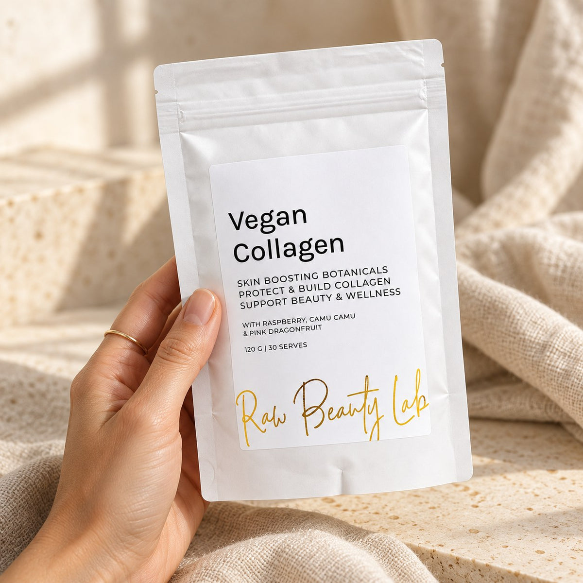 Hand holding the Vegan Collagen Booster pouch