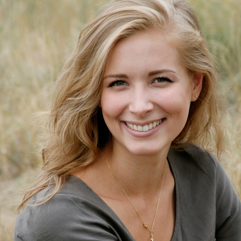 woman smiling with glowing skin and hair