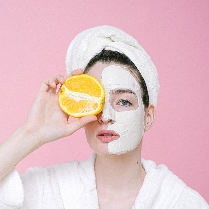 woman with orange for vitamin c